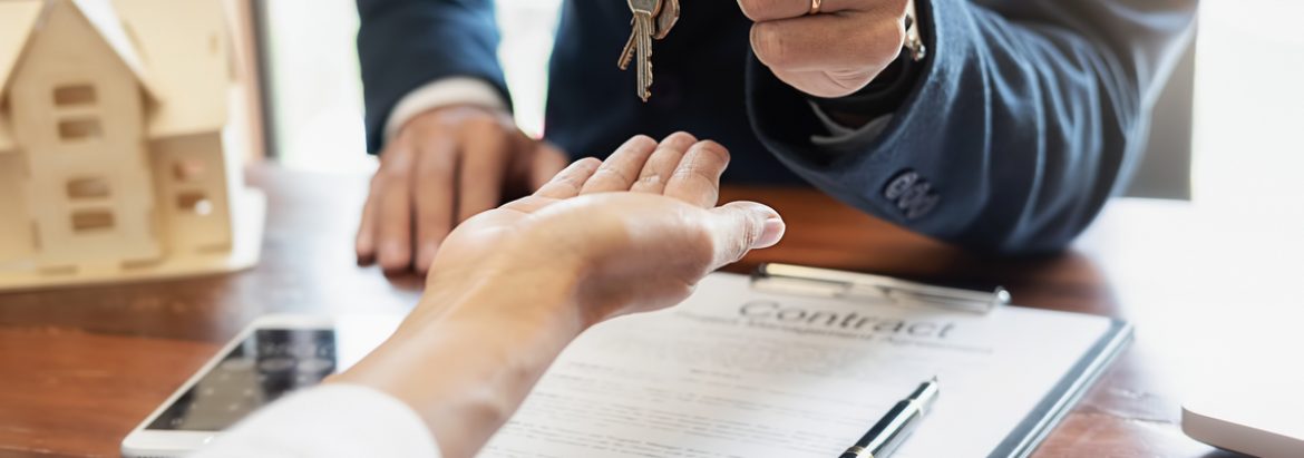 man handing over keys to new owner after signing contract