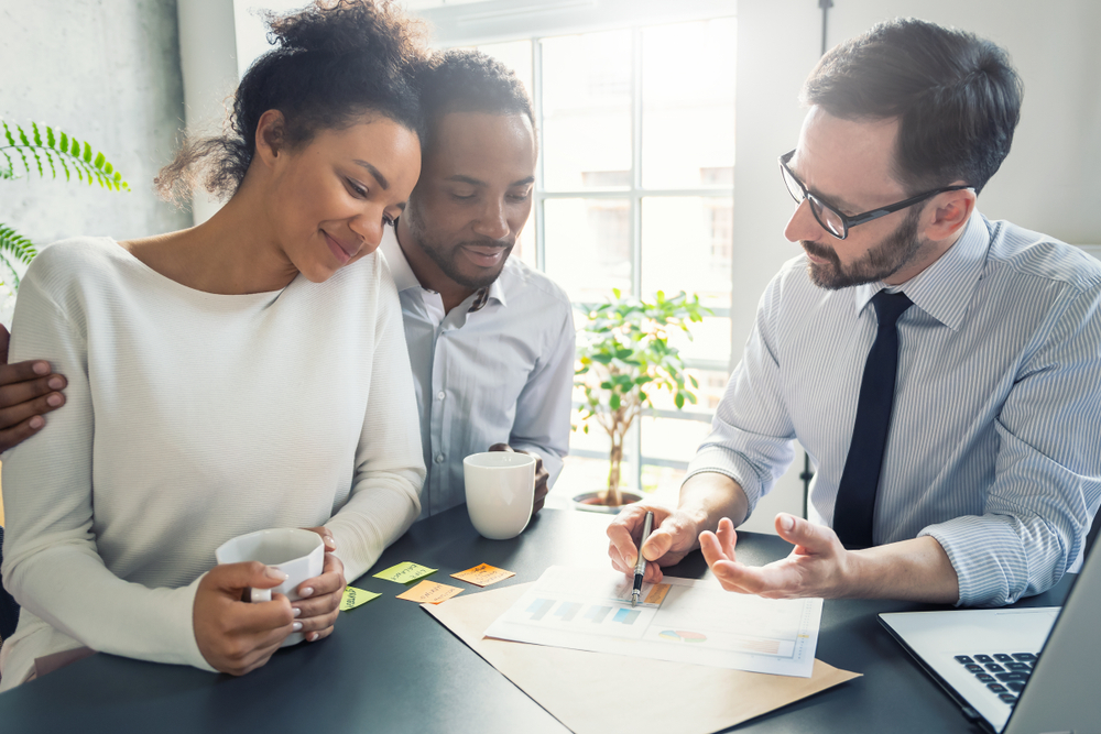 young couple working with a real estate agent