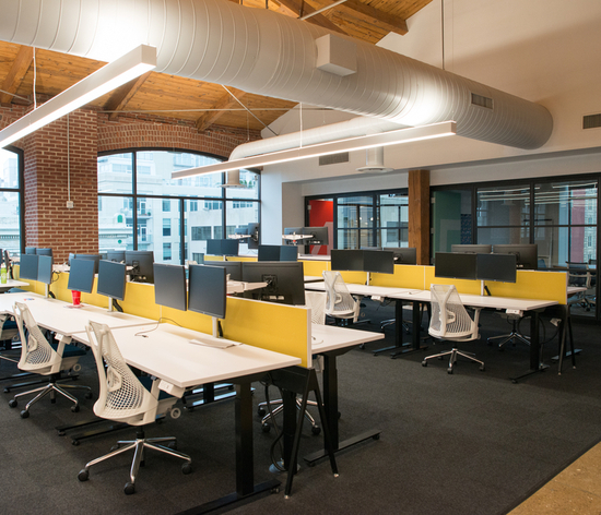 An office space with rows of workstations