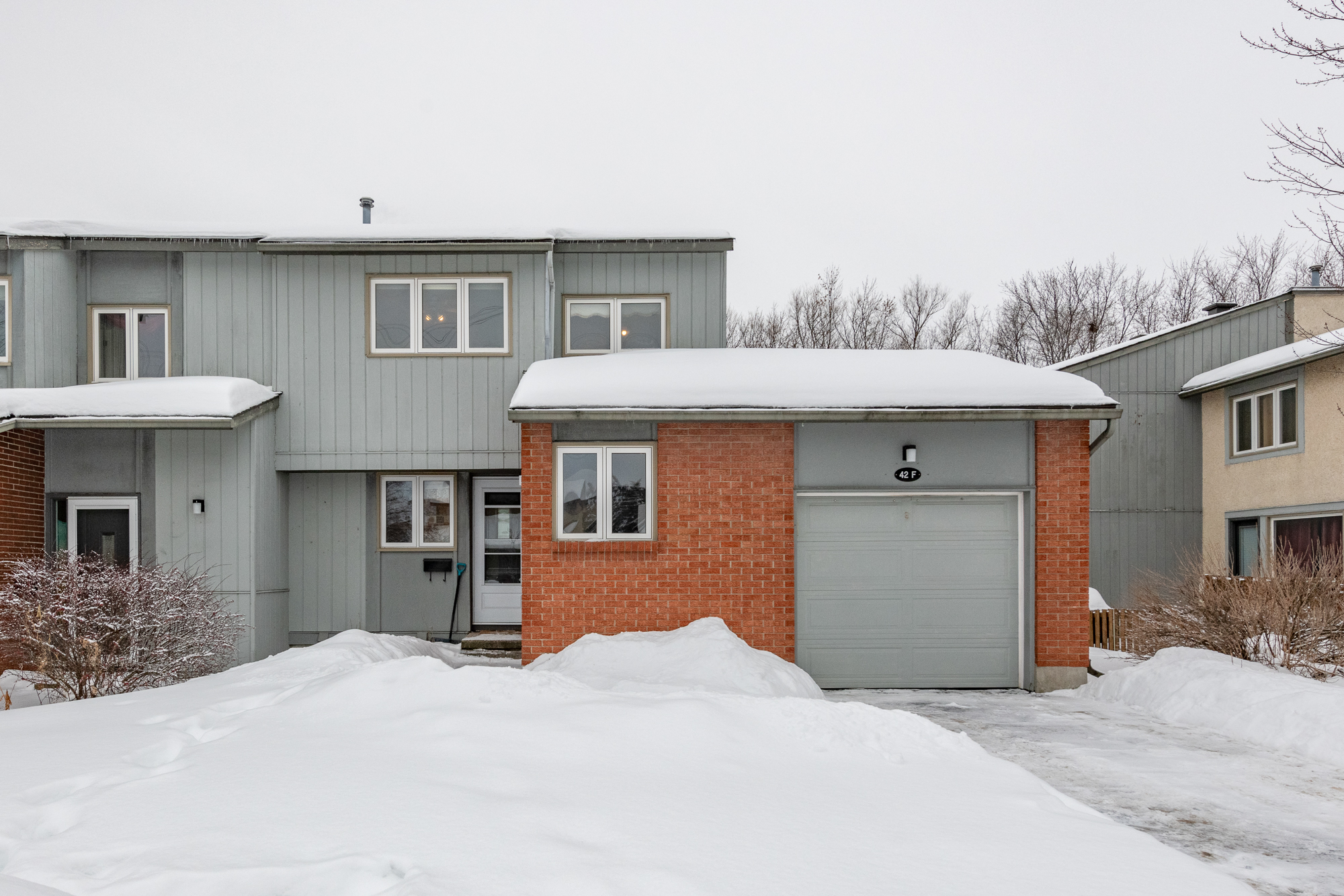 a town house with snow covered lawns