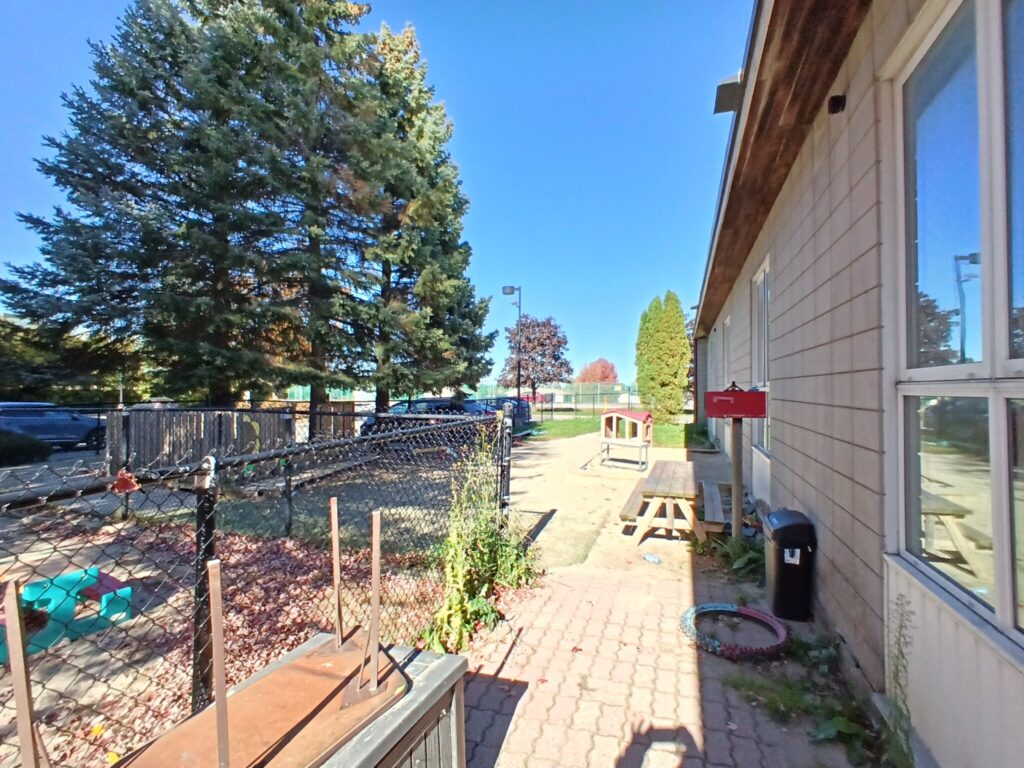 Fenced outdoor area beside the building at 2244 Russell Road, Ottawa