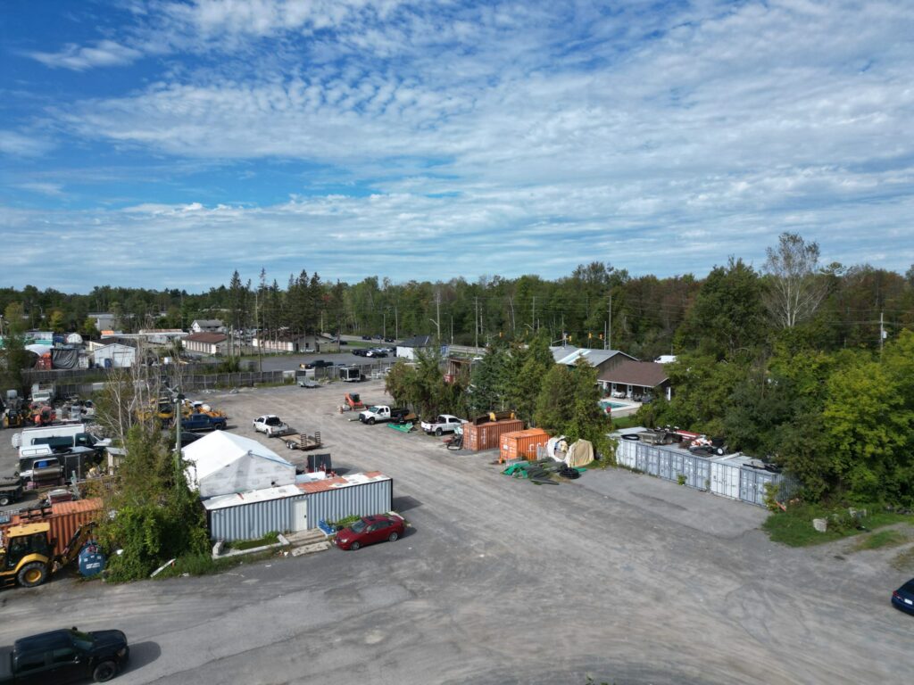 Large yard at 2538 Leitrim Road with storage buildings and containers