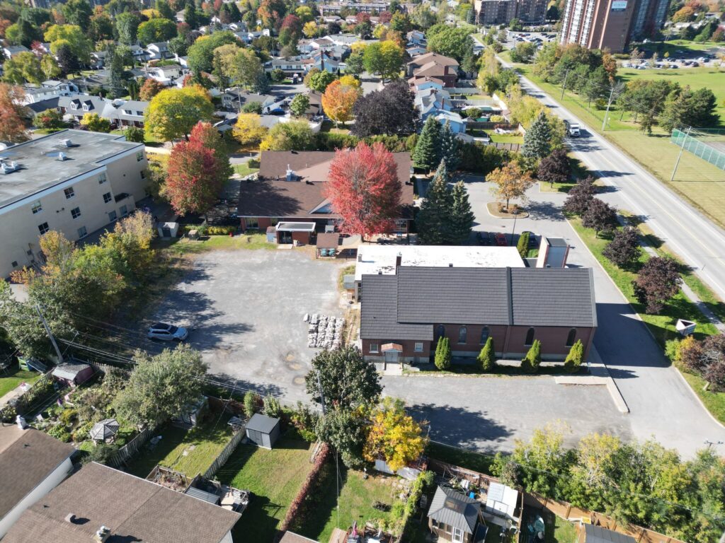 Aerial view of the large rear parking lot at 2244 Russell Road, Ottawa