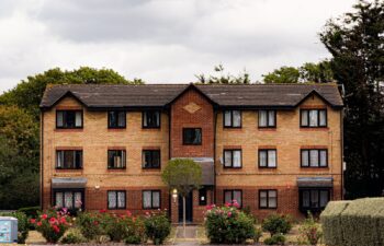 three-storey-low-rise-apartment-building-pitched-roof Stand-alone three-storey low-rise apartment building with a low-pitched roof
