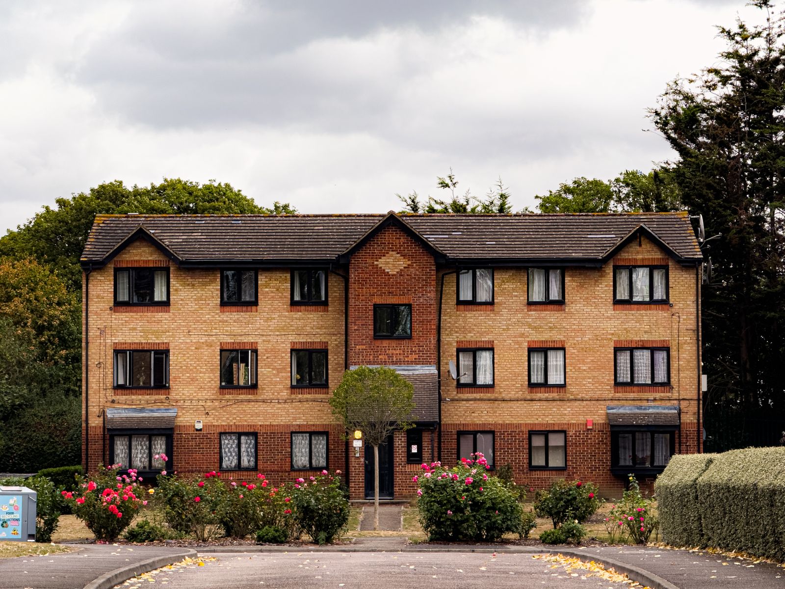 three-storey-low-rise-apartment-building-pitched-roof Stand-alone three-storey low-rise apartment building with a low-pitched roof